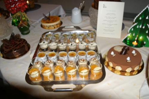 a tray of cupcakes and desserts on a table at Château des Monthairons Hôtel Restaurant GastroMaison Spa privatif in Les Monthairons