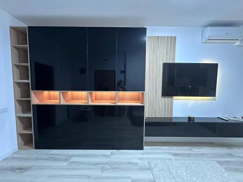 a large black cabinet with a tv in a room at Luxury 1 bedroom apartment in Bucharest