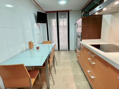 a kitchen with a counter and a blue counter top at Apartamentos Ciudad del Calzado in Arnedo