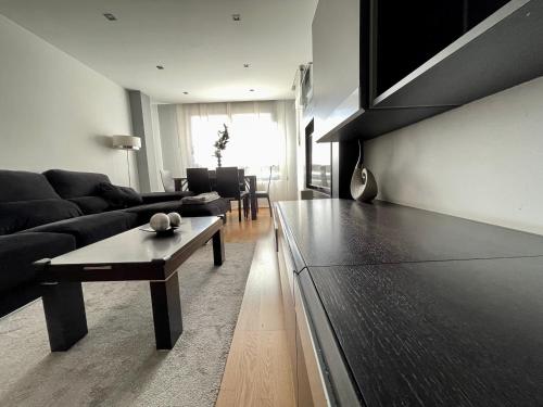 a living room with a couch and a coffee table at Apartamentos Ciudad del Calzado in Arnedo
