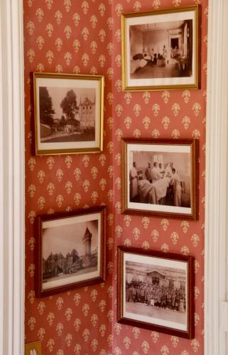 a group of pictures hanging on a wall at Château des Monthairons Hôtel Restaurant GastroMaison Spa privatif in Les Monthairons