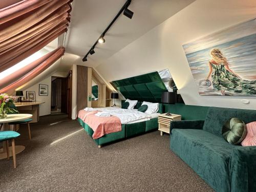 a hotel room with a bed and a couch at Pensjonat Melaxa in Węgierska Górka