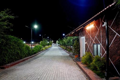 a cobblestone street at night with a building at GREEN MOUNT RESORTS in Malaiyāndipattanam