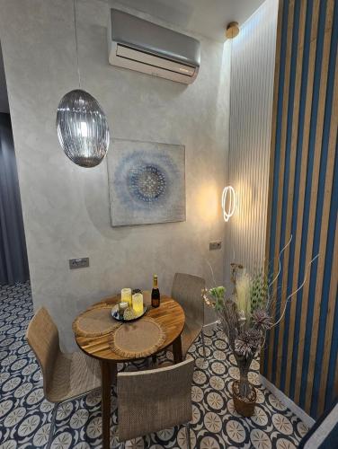 a dining room with a table and chairs and a fan at Lounge garden sea relax in Valencia