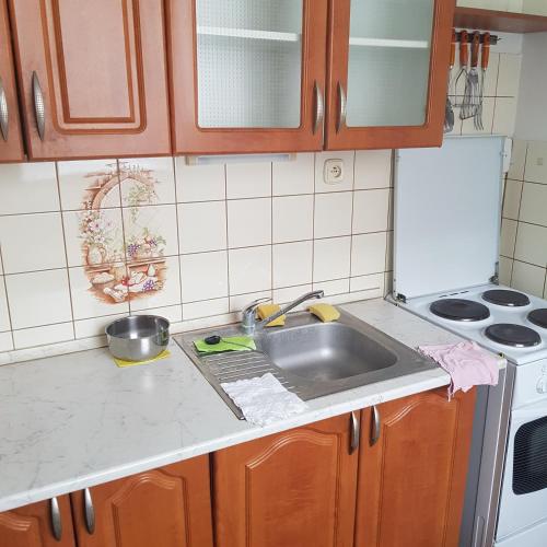 a kitchen counter with a sink and a stove at Apartman Trajan in Piešťany