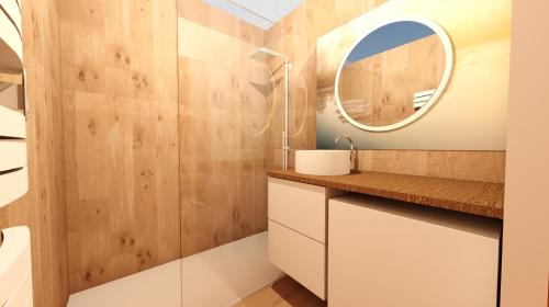 ein Bad mit einem Waschbecken und einem Spiegel in der Unterkunft Appartement moderne avec parking in Blois