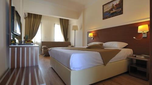 a bedroom with a large bed in a hotel room at SOZ HOTEL in Bodrum City