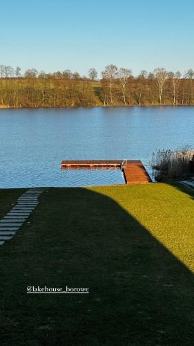a lake with a dock in the middle of it at Lake House Borowe in Borowe