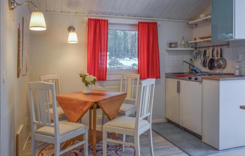 a small kitchen with a table and chairs in a kitchen at Lovely Home In Hammar With Lake View in Hammarö