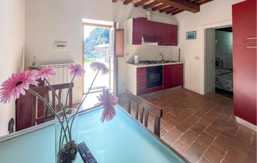 a kitchen and a pool in a room with flowers in a vase at 1 Bedroom Nice Apartment In Gubbio in Gubbio