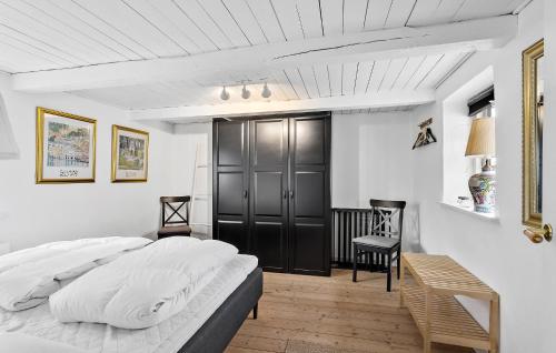 ルーケベングにあるOlivias Husのベッドルーム1室(大型ベッド1台、黒いキャビネット付)