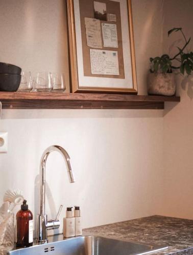 a kitchen counter with a sink and a picture on the wall at Spacious villa with view - 5BR - FREE parking - Great Wi-Fi in Bergen