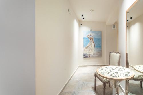 a room with a table and a painting on the wall at Mpikas Holidays in Ierissos