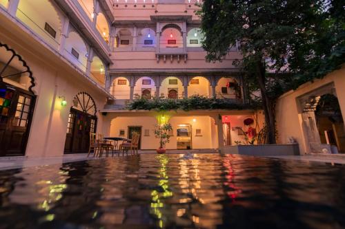 an indoor courtyard of a building with a pool at The Fern Bambora Fort, Bambora, Udaipur in Udaipur