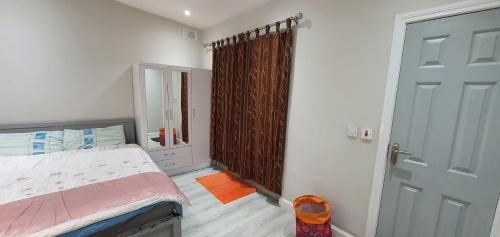 a small bedroom with a bed and a door at Studio with Private Kitchen in Dublin
