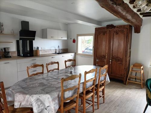 a kitchen with a table and chairs and a table and a kitchen at Maison de 3 chambres avec jardin clos et wifi a Offranville a 4 km de la plage in Offranville