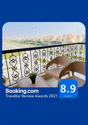 a balcony with two chairs and a view of the ocean at Casa Do Cairo-AlRehab in Burg el-Ḥudûd