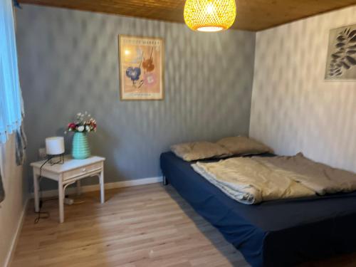 a bedroom with two beds and a table and a lamp at 5 minute walk to Lego house - private studio apartment with Garden in Billund