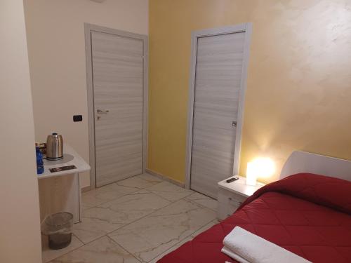 a bedroom with a bed and a table with a lamp at Soleil in Nicosia