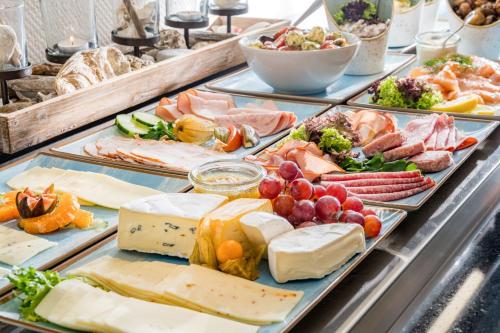 a buffet with many different types of cheese and meats at BeachSide in Eckernförde