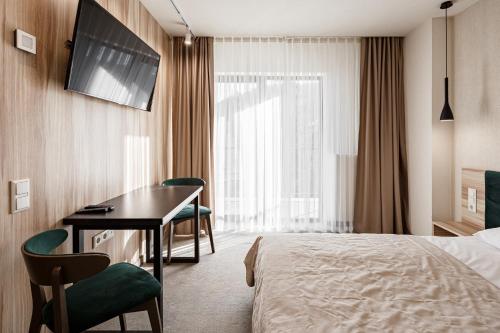 Postel nebo postele na pokoji v ubytování HVOYA Apart-Hotel & SPA