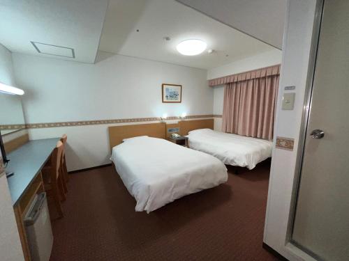 Postel nebo postele na pokoji v ubytování Hotel Alpha-One Marugame