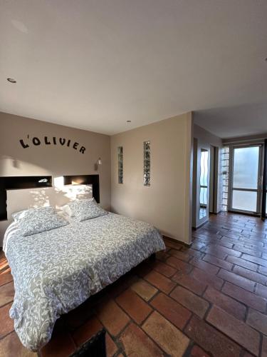 a bedroom with a large bed in a room at La Chambre de l'Olivier in Champigny-sur-Marne