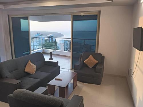 a living room with a couch and two chairs at 2 BHK SKY water Apartment(SKY 2) in Marmagao