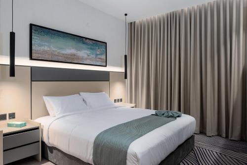 a hotel room with a bed and a large window at فندق لفيف الخالدية - Lafif Hotel Al-Khaldia in Al Madinah