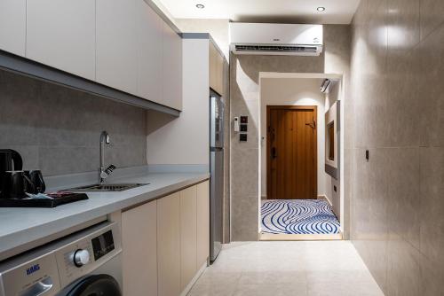 a kitchen with a hallway leading to a door with a bed at فندق لفيف الخالدية - Lafif Hotel Al-Khaldia in Al Madinah