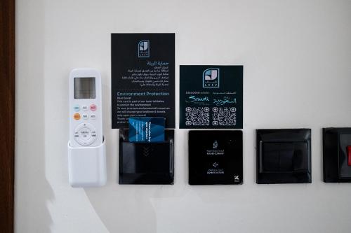 a wall with a wii remote and some black boxes at فندق لفيف الخالدية - Lafif Hotel Al-Khaldia in Al Madinah