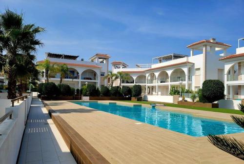 a large house with a swimming pool in front of it at Casa Marietha Apartment with swimming pool and roof terrace in Rojales