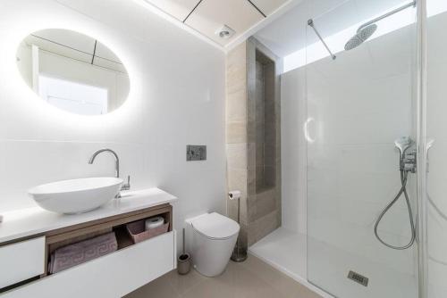a white bathroom with a sink and a shower at Casa Marietha Apartment with swimming pool and roof terrace in Rojales