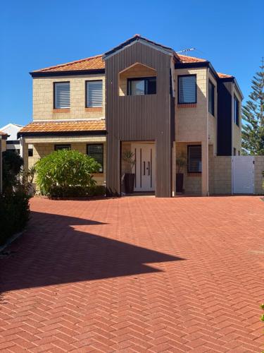 a brick driveway in front of a house at Hillarys Sea-View Panoramic Living in Perth