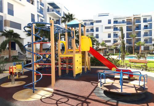 a playground with a slide and a slide at Appartement de Luxe MARTIL COSTA MAR Pour Familles in Martil