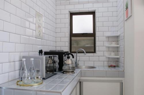 a kitchen counter with a sink and a window at Shark Island Guesthouse in Lüderitz