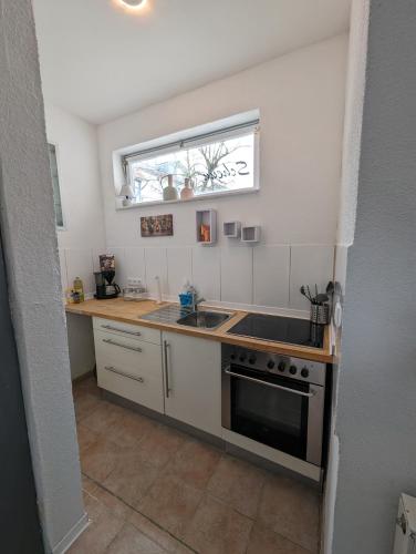 a kitchen with a sink and a stove at Studio Ahnatal in Weimar