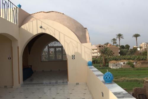 an entry to a building with an archway at Mogran Guest House in Luxor