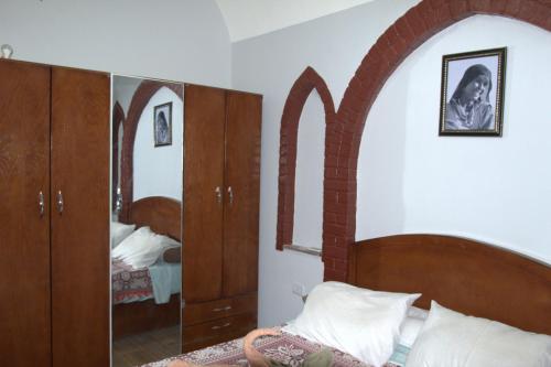 a bedroom with a bed and a mirror at Mogran Guest House in Luxor