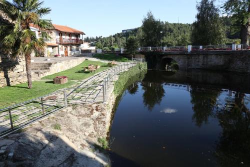 a bridge over a river with a train on it at Casa de Sao Cristovao in Boticas