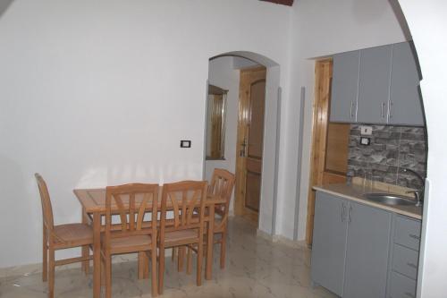 a kitchen and dining room with a table and chairs at Mogran Guest House in Luxor