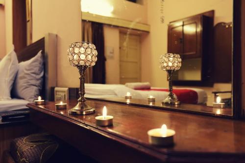 a room with a mirror and candles on a table at EMINENCE - PALM RESIDENCY (1.5 KM FROM NAKKI LAKE) in Mount Ābu
