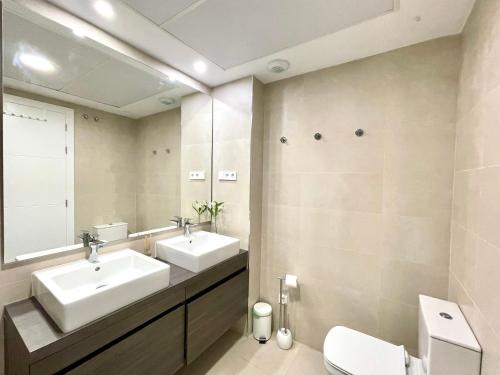 a bathroom with two sinks and a mirror at Paradise in Fuengirola in Fuengirola