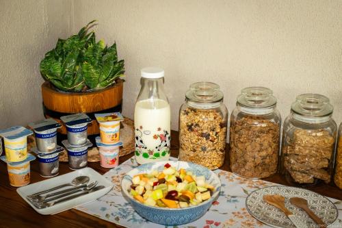 a table with jars of food and a bowl of fruit at Munsterland Guest Farm in Outjo