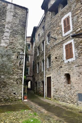 an old stone building with a street next to it at Casa EdEn in Isolabona