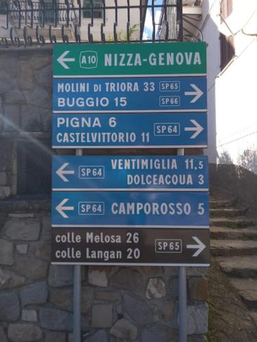 a group of street signs in front of a building at Casa EdEn in Isolabona