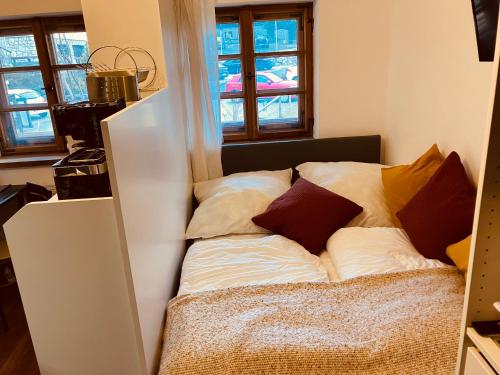 a bed with pillows on it in a room at ApartmentMICRO in Pfronten