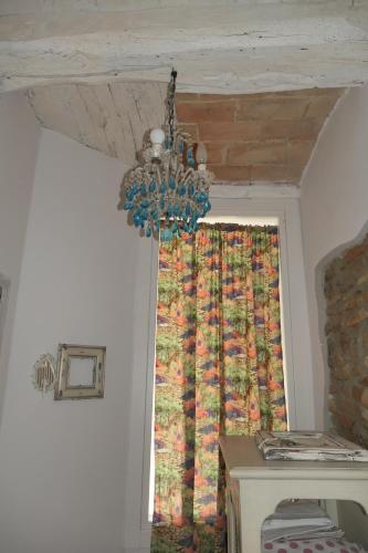 a chandelier hanging from a ceiling with a window at BB Lady in Castelvetro di Modena