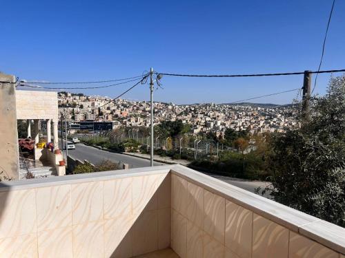 a view of a city from a balcony at Red rose apartment in Jerash