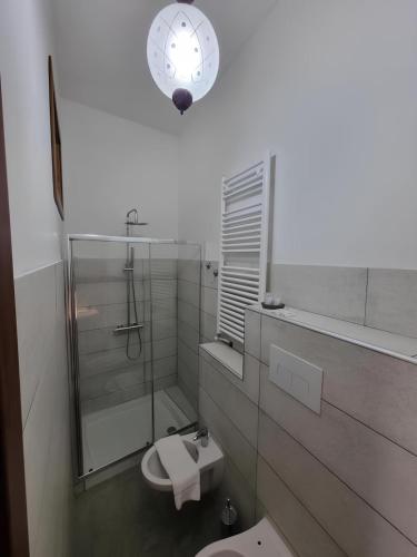 a bathroom with a toilet and a clock on the wall at Borgo Scorciarini B&B in Piedimonte Matese